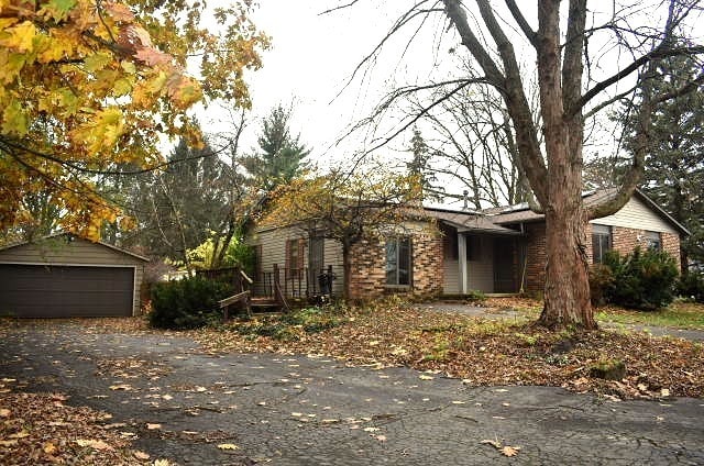 view of front of property featuring a garage and an outbuilding