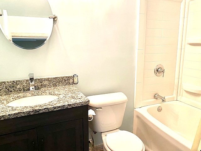 full bathroom featuring vanity, toilet, and tiled shower / bath combo