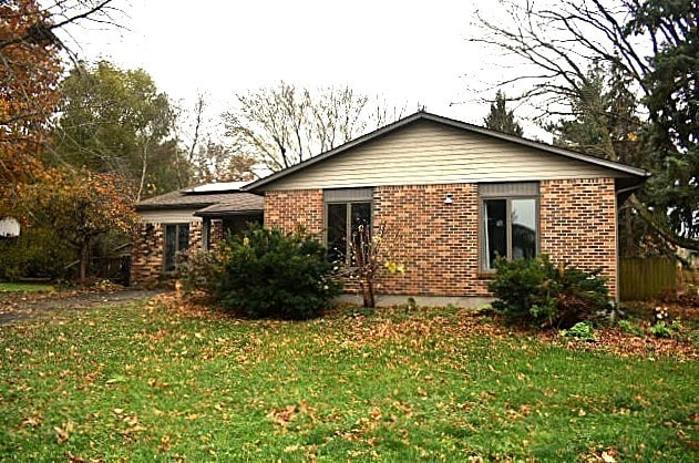 rear view of property with a yard