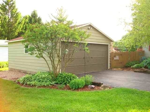 garage featuring a lawn