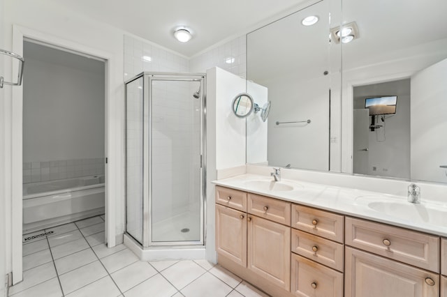 bathroom with tile patterned flooring, vanity, and independent shower and bath