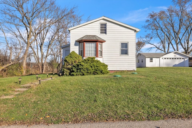 view of front of property with a front yard and a garage