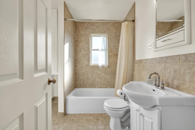 full bathroom with vanity, tile patterned floors, toilet, tile walls, and tasteful backsplash