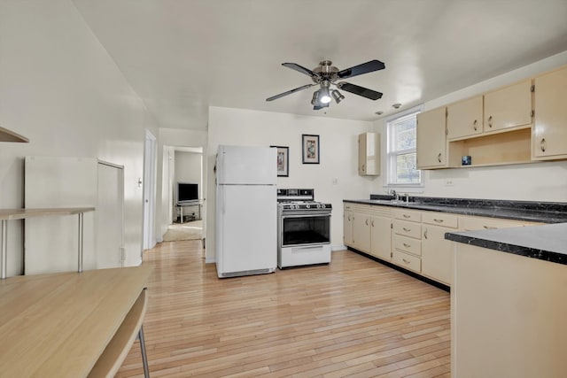 kitchen featuring white appliances, sink, ceiling fan, cream cabinetry, and light hardwood / wood-style floors