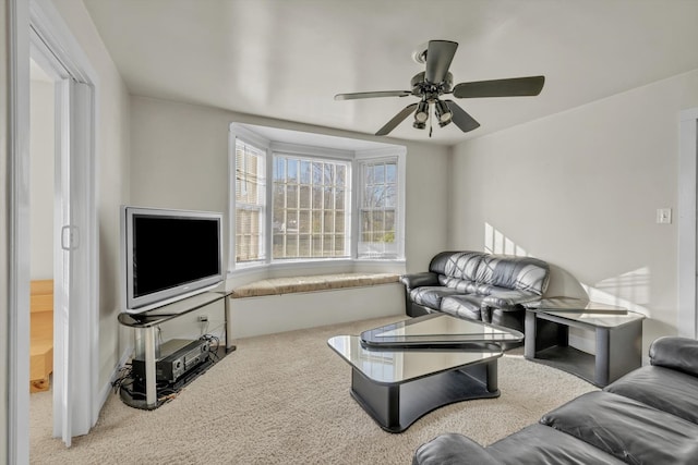 carpeted living room with ceiling fan