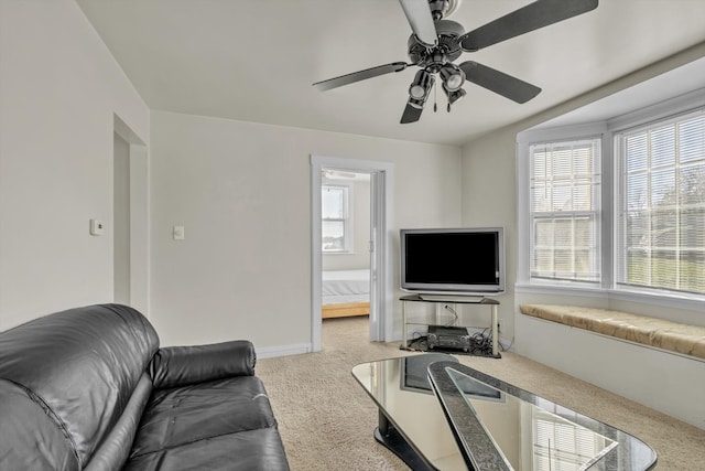 carpeted living room with ceiling fan