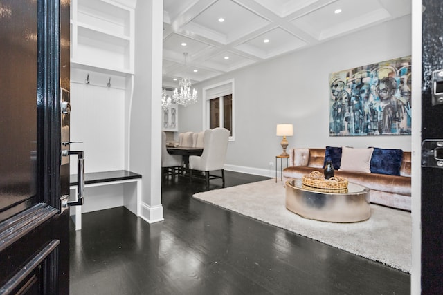 living room featuring coffered ceiling, beam ceiling, hardwood / wood-style flooring, and a chandelier