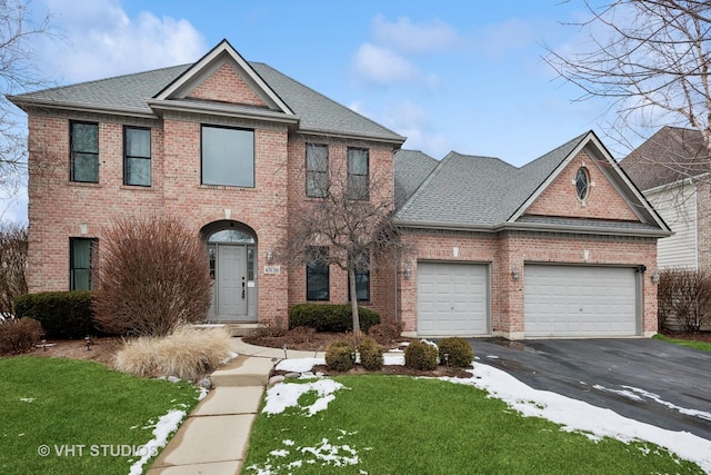 view of front of house featuring a garage and a front yard