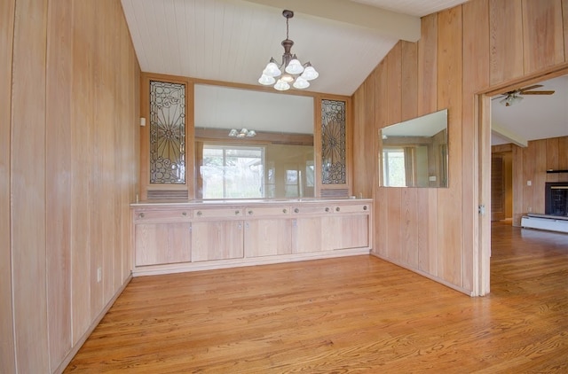 interior space featuring vaulted ceiling with beams, light brown cabinets, a healthy amount of sunlight, and light hardwood / wood-style flooring