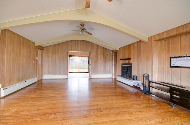 unfurnished living room featuring lofted ceiling with beams, light wood-type flooring, and a baseboard heating unit