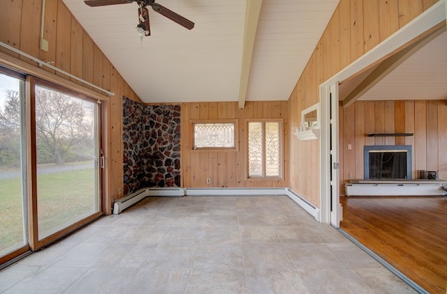 unfurnished sunroom featuring a fireplace, lofted ceiling with beams, a baseboard radiator, and ceiling fan