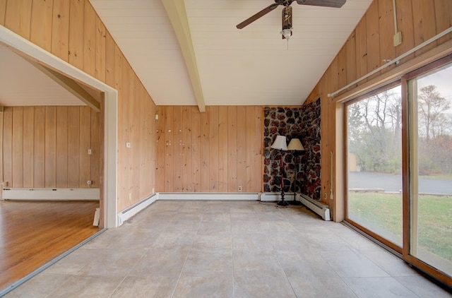 interior space featuring ceiling fan, a baseboard heating unit, wooden walls, lofted ceiling with beams, and light hardwood / wood-style floors