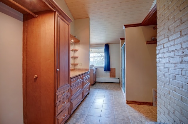 interior space featuring an enclosed shower, vanity, baseboard heating, wooden ceiling, and tile patterned flooring