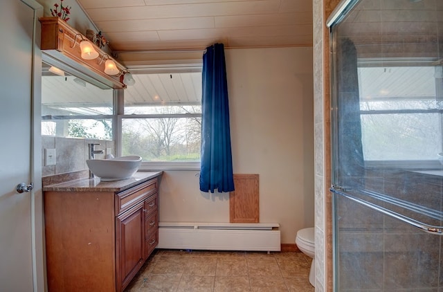 bathroom with tile patterned flooring, vanity, toilet, and a baseboard heating unit