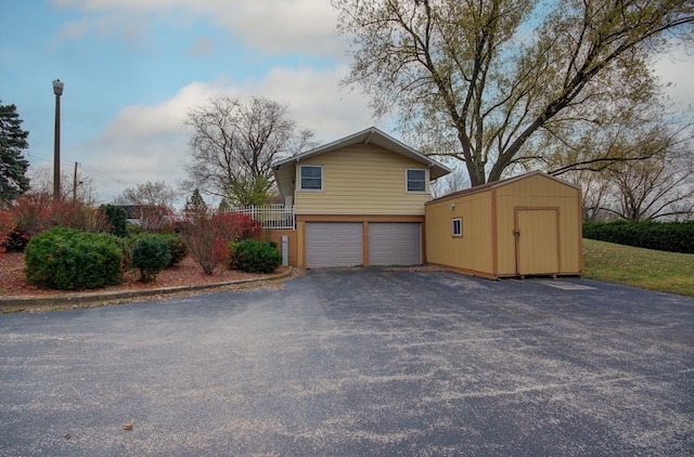 view of side of property with a shed and a garage