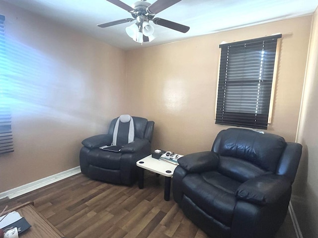 sitting room with dark hardwood / wood-style floors and ceiling fan