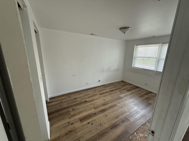 1402 Berkeley Ave, Chicago Heights, IL 60411 - unfurnished bedroom featuring wood finished floors and baseboards