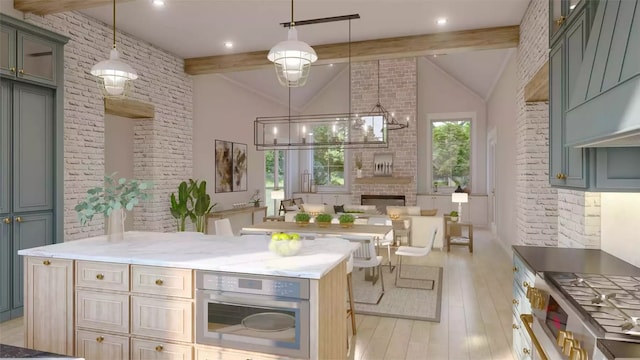 kitchen featuring appliances with stainless steel finishes, beam ceiling, decorative light fixtures, light hardwood / wood-style flooring, and a fireplace