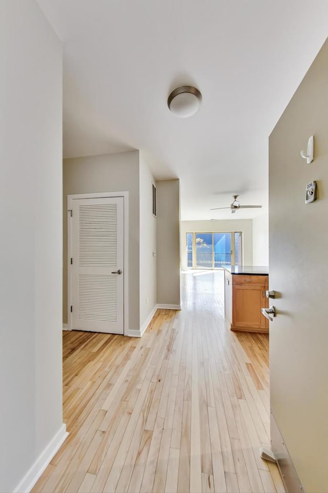 corridor with light hardwood / wood-style flooring