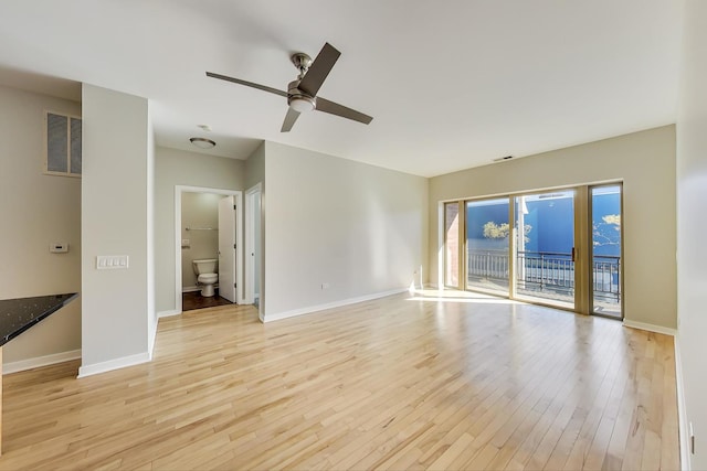 empty room with light wood-type flooring and ceiling fan