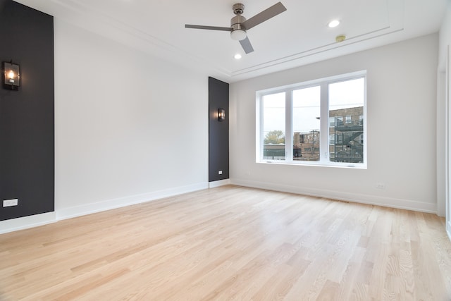 spare room with light hardwood / wood-style flooring and ceiling fan