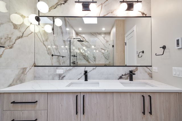 bathroom featuring a tile shower, vanity, and backsplash