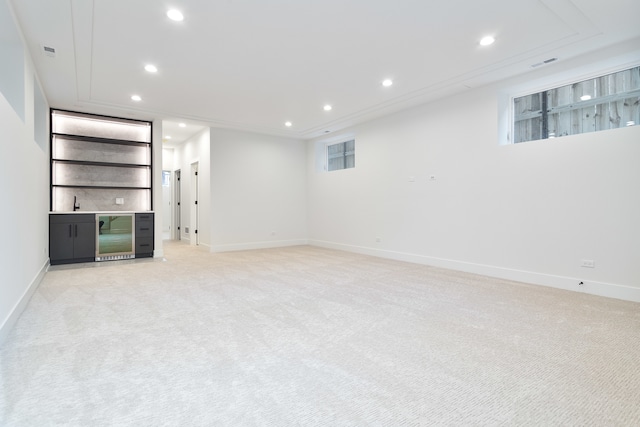 basement featuring light carpet and beverage cooler