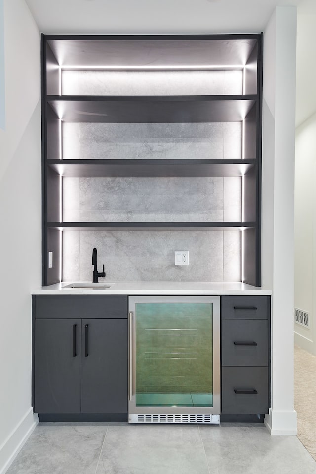 bar with built in features, sink, wine cooler, and light carpet