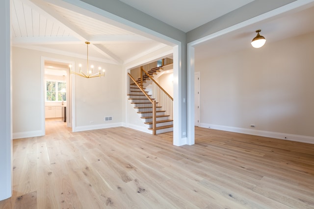 spare room with vaulted ceiling with beams, light hardwood / wood-style flooring, and a notable chandelier