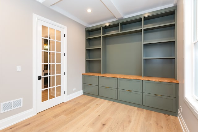 interior space with beamed ceiling and light hardwood / wood-style floors