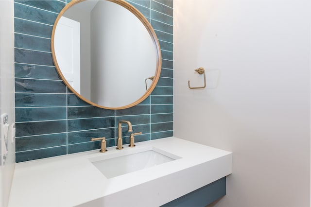 bathroom featuring vanity and decorative backsplash