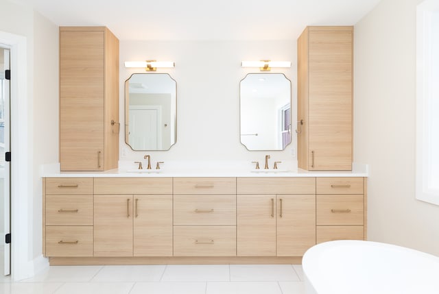 bathroom featuring tile patterned floors, vanity, and a tub