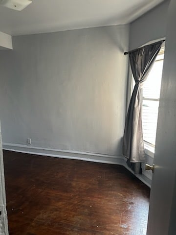 spare room with dark hardwood / wood-style flooring