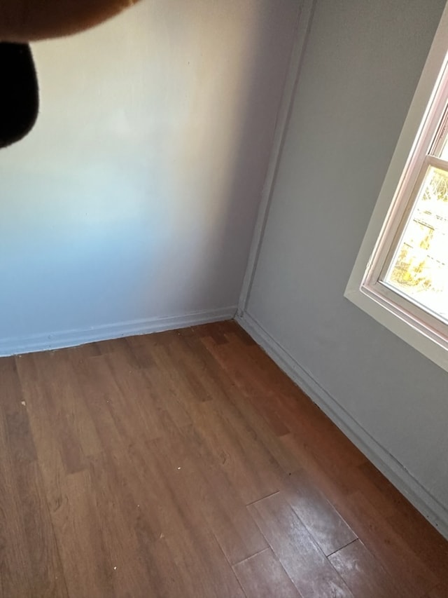 unfurnished room featuring hardwood / wood-style flooring