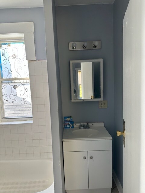 bathroom with vanity and a bathing tub