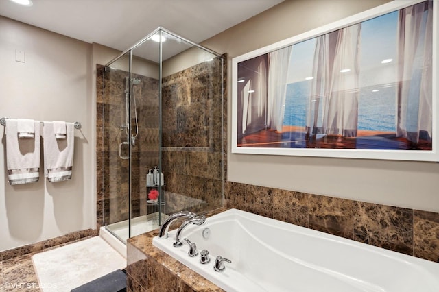 bathroom featuring separate shower and tub