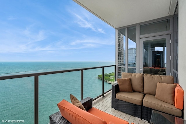 balcony with an outdoor living space and a water view