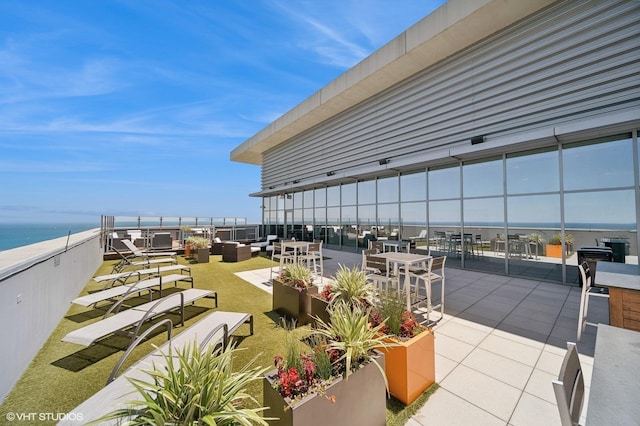 view of patio with a water view and an outdoor hangout area