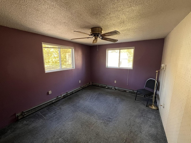 empty room with dark colored carpet, a textured ceiling, a baseboard radiator, and ceiling fan