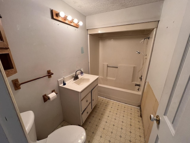 full bathroom with shower / washtub combination, vanity, a textured ceiling, and toilet