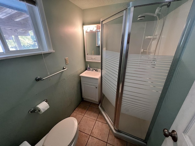 bathroom featuring toilet, vanity, tile patterned floors, and walk in shower