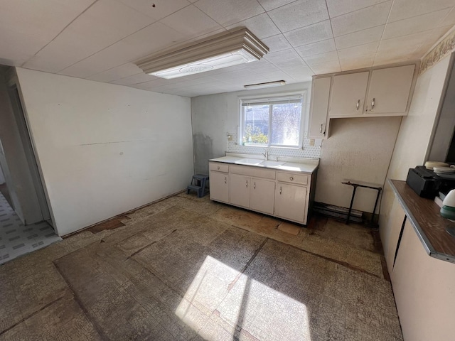 kitchen featuring white cabinetry and sink