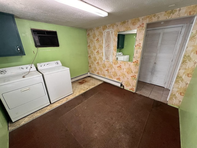 washroom with tile patterned flooring, a baseboard heating unit, a textured ceiling, and washing machine and clothes dryer