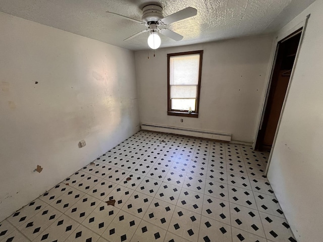 empty room featuring a textured ceiling, a baseboard radiator, and ceiling fan