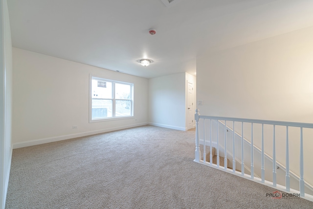 unfurnished room featuring light colored carpet