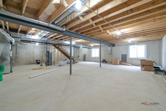 basement with heating unit, electric panel, and water heater