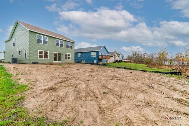 back of house with central AC unit