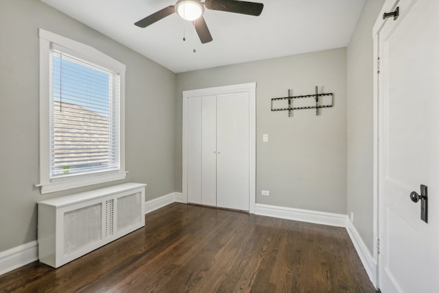 unfurnished bedroom featuring a closet, ceiling fan, and dark wood-type flooring