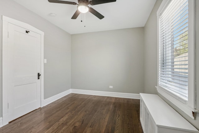 empty room featuring ceiling fan and dark hardwood / wood-style floors