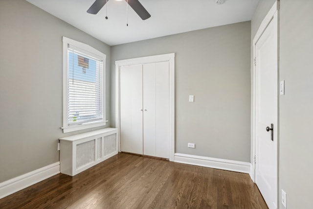 unfurnished bedroom featuring a closet, ceiling fan, and dark wood-type flooring